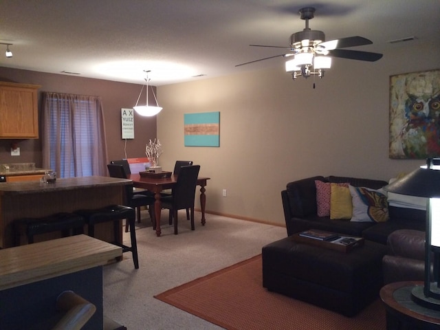 carpeted living room featuring ceiling fan