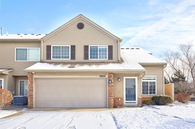 view of front of house featuring cooling unit and a garage