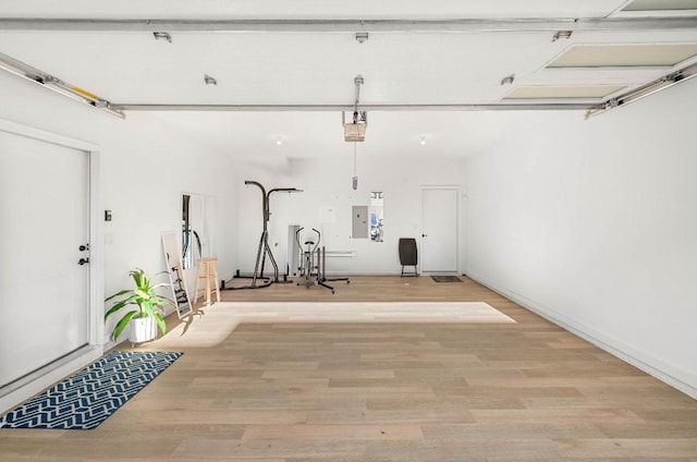 garage featuring electric panel and a garage door opener