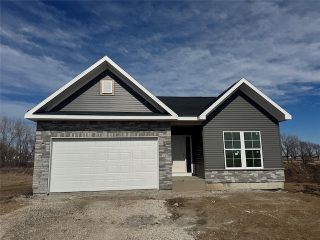 view of front of property with a garage, stone siding, and dirt driveway