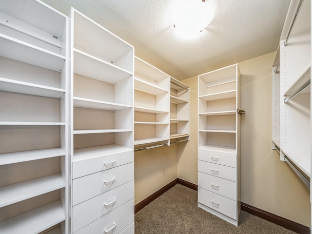 spacious closet featuring dark carpet