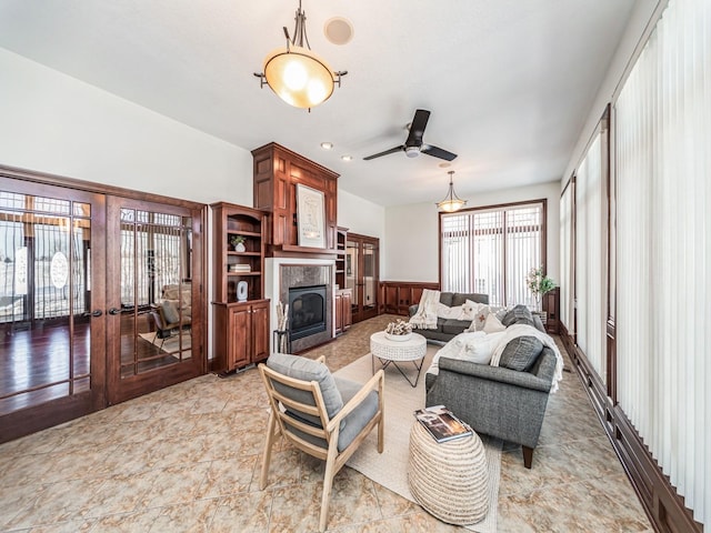 living room featuring ceiling fan and french doors