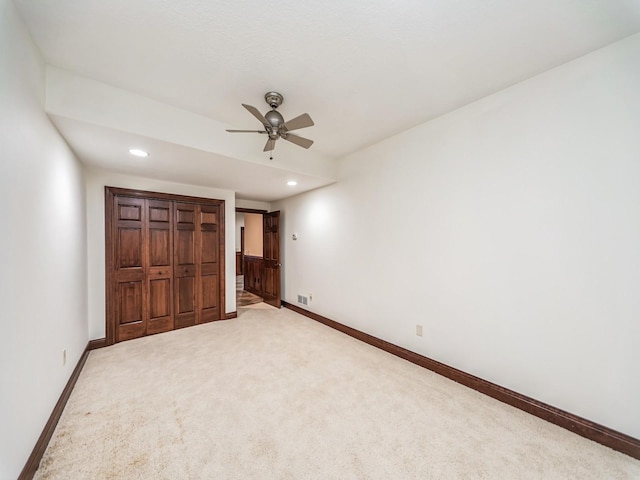 unfurnished bedroom with ceiling fan and carpet floors