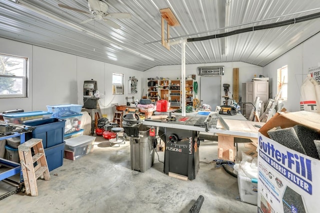 garage with a workshop area, an AC wall unit, and ceiling fan