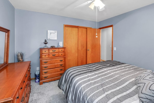 bedroom with light colored carpet, a closet, and ceiling fan