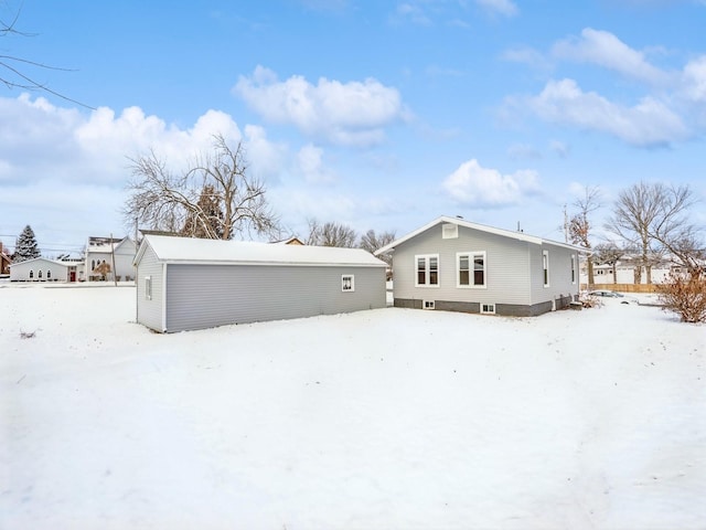 view of snow covered rear of property