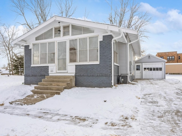 view of front of house with a garage and an outdoor structure