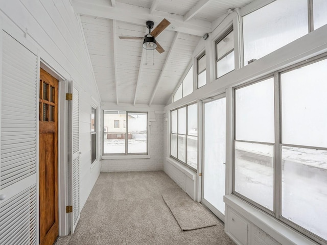 unfurnished sunroom featuring lofted ceiling with beams and ceiling fan