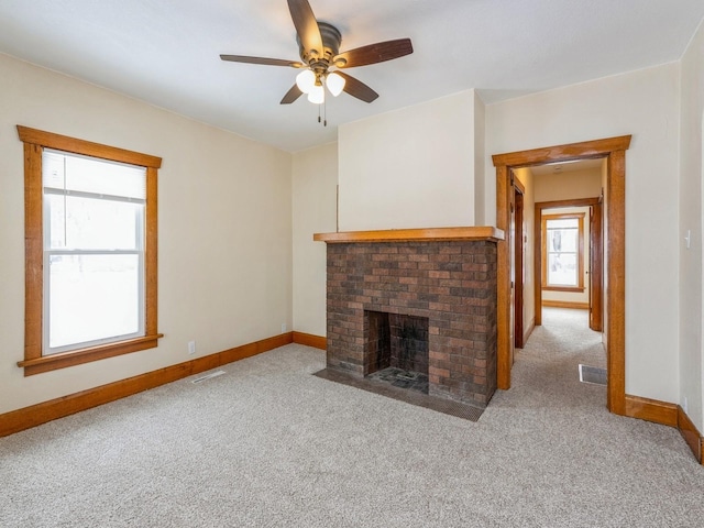 unfurnished living room featuring light carpet, a fireplace, and ceiling fan