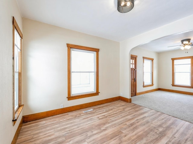 unfurnished room with light hardwood / wood-style flooring and ceiling fan