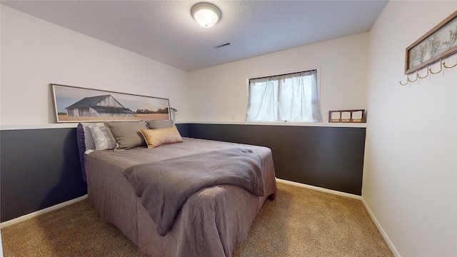 bedroom with carpet flooring and a textured ceiling