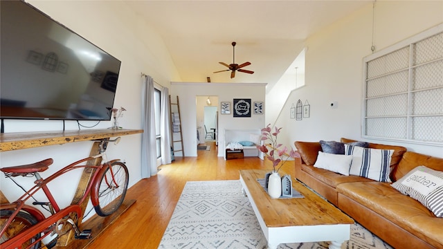 living room featuring ceiling fan, light hardwood / wood-style flooring, and lofted ceiling