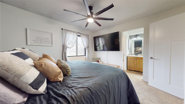 carpeted bedroom with connected bathroom, ceiling fan, and a textured ceiling