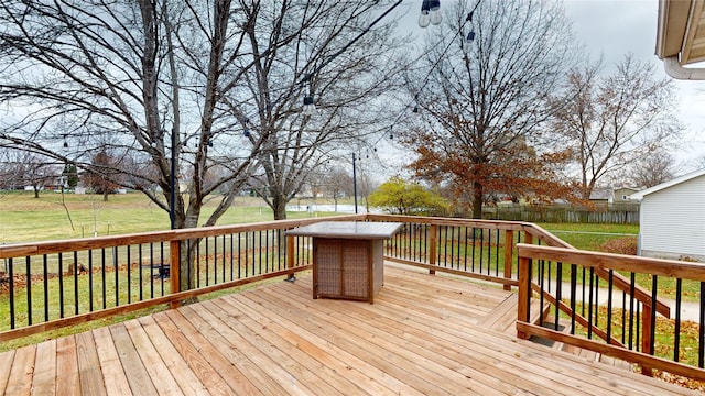 wooden terrace featuring a lawn