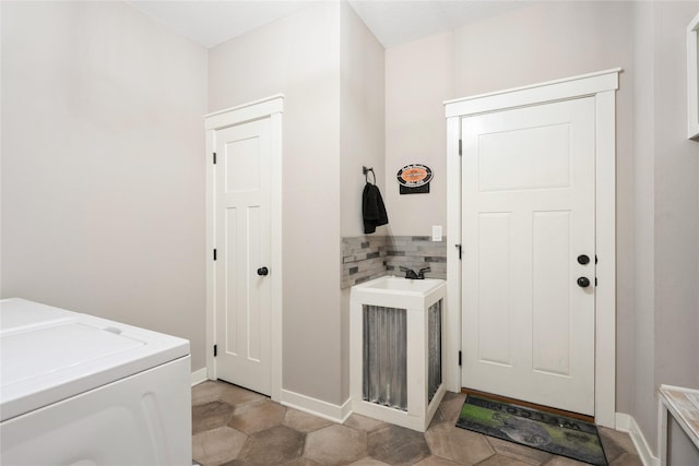 clothes washing area featuring sink and independent washer and dryer