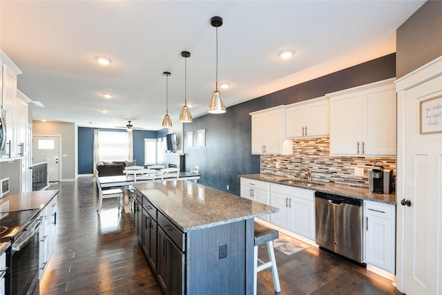 kitchen with white cabinets and appliances with stainless steel finishes