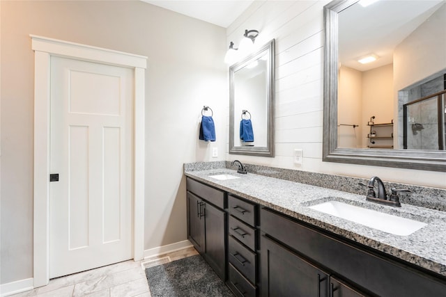 bathroom featuring tile patterned flooring, an enclosed shower, and vanity