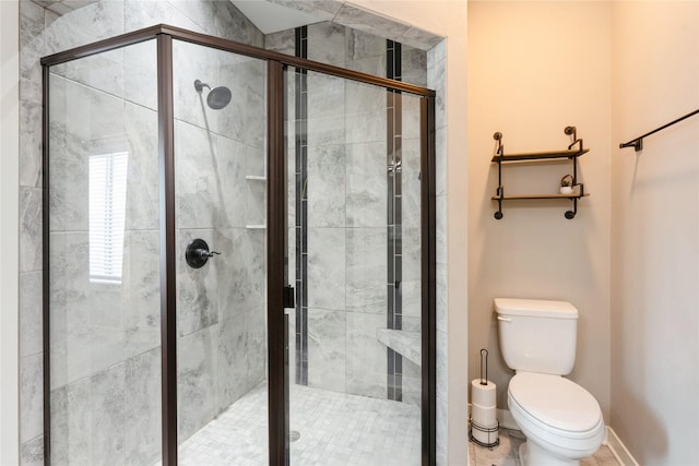 bathroom featuring an enclosed shower and toilet