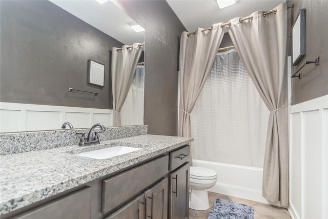 full bathroom featuring tile patterned flooring, toilet, vanity, and shower / bath combination with curtain