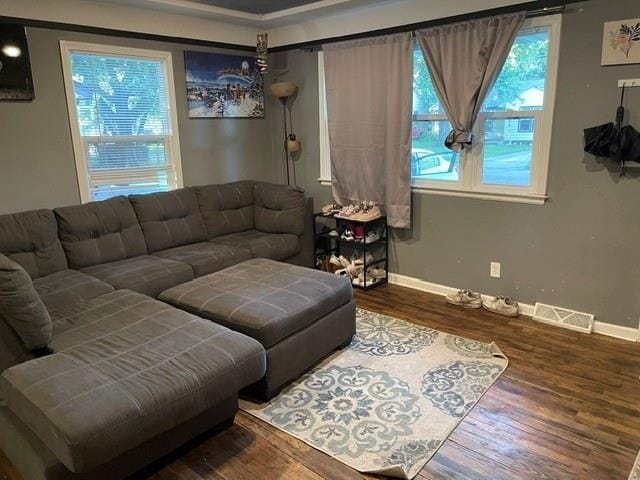 living room with dark hardwood / wood-style floors and ornamental molding