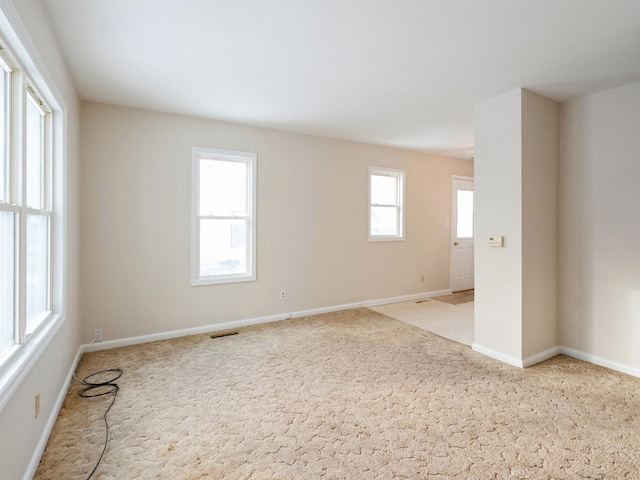 spare room with light colored carpet