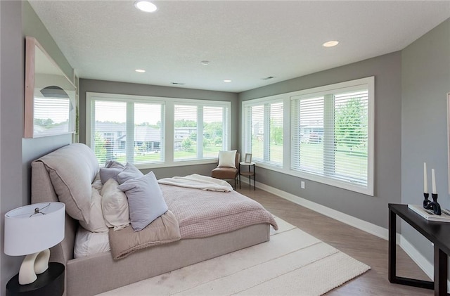 bedroom with hardwood / wood-style flooring