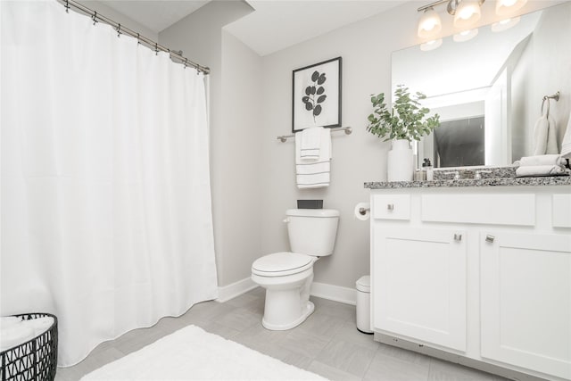 bathroom featuring vanity, tile patterned floors, and toilet