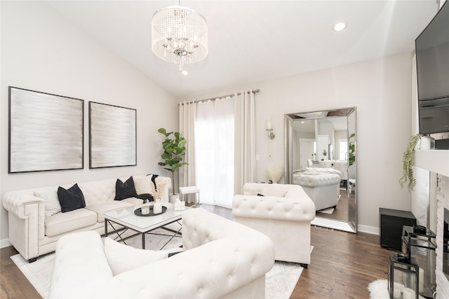 living room featuring vaulted ceiling, dark wood-type flooring, a wealth of natural light, and an inviting chandelier