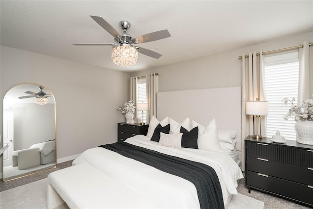 bedroom featuring ceiling fan and light colored carpet