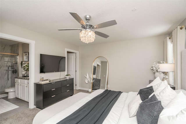 carpeted bedroom with ceiling fan and ensuite bathroom