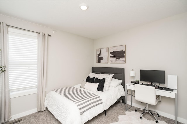 carpeted bedroom featuring multiple windows