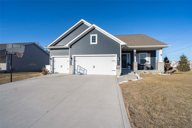 craftsman house with a garage and a front lawn