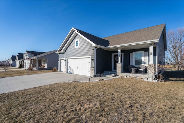 view of front facade featuring a porch, a garage, and a front yard