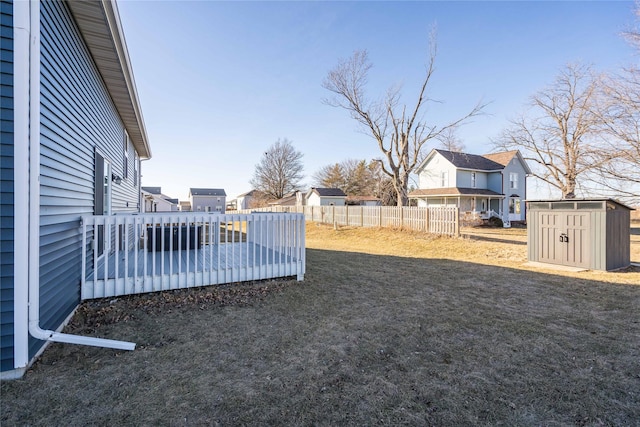 view of yard with a deck and a storage shed