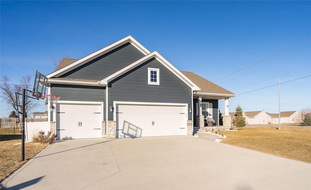 craftsman-style house featuring a garage and a front yard