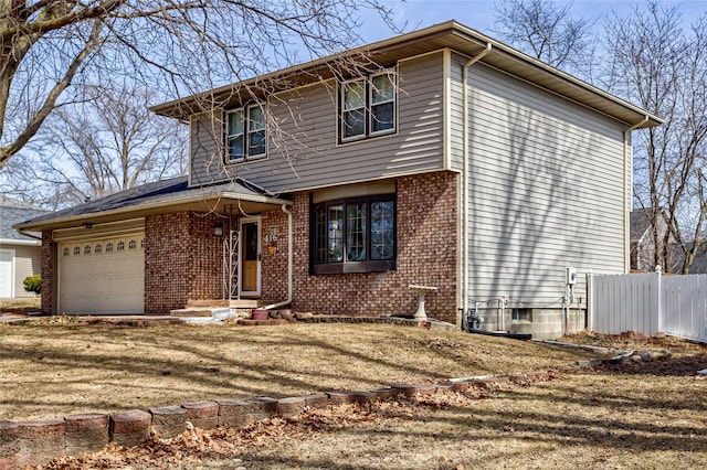 view of front facade with brick siding, driveway, a garage, and fence