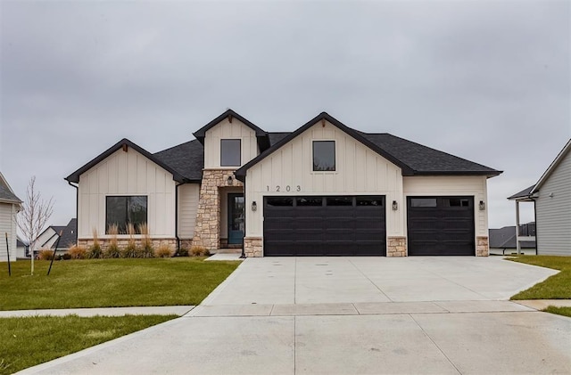 modern inspired farmhouse with a front yard and a garage