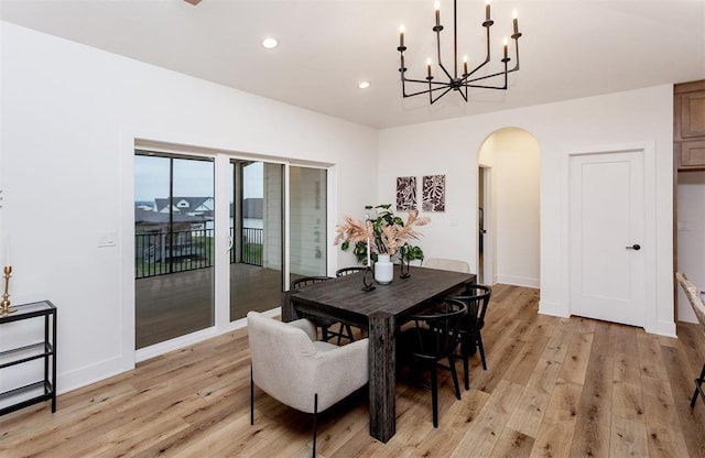 dining room with an inviting chandelier and light hardwood / wood-style flooring