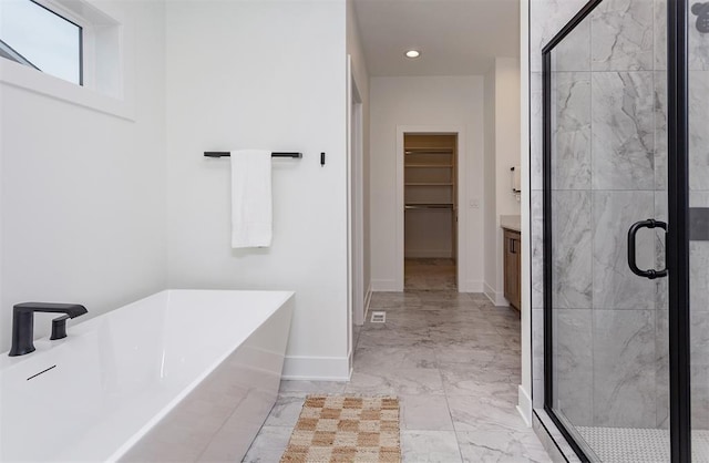 bathroom featuring vanity and separate shower and tub