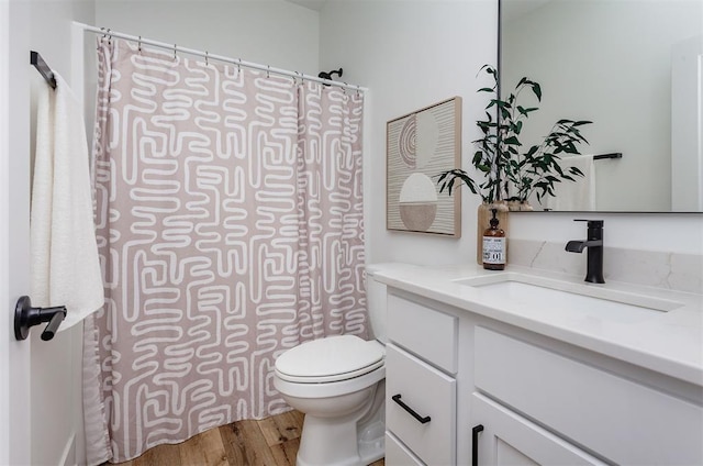 bathroom featuring hardwood / wood-style flooring, vanity, and toilet