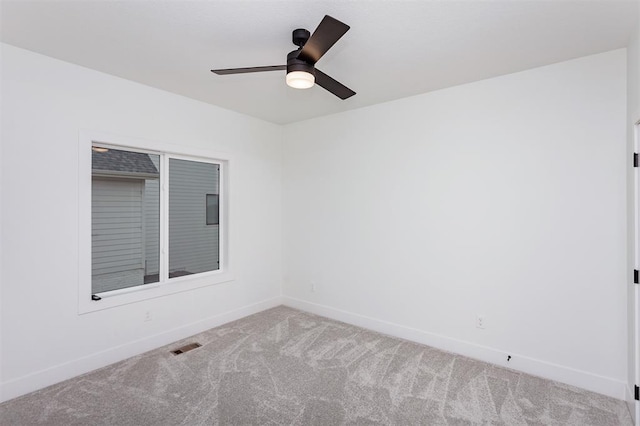 carpeted empty room featuring ceiling fan