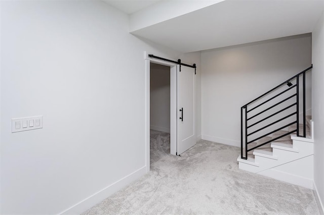 interior space featuring a barn door and carpet floors