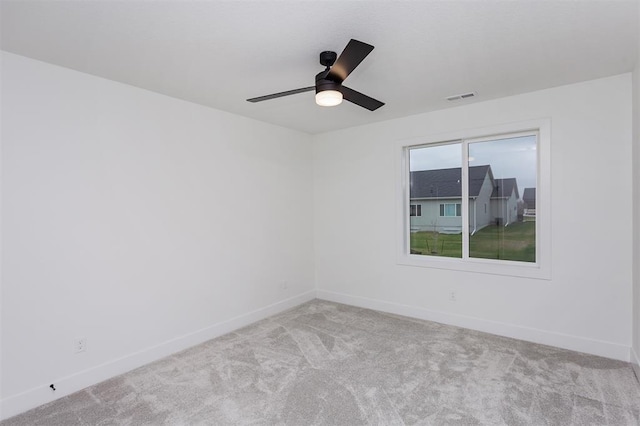 empty room featuring light colored carpet and ceiling fan