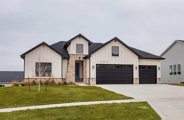 modern inspired farmhouse with a garage and a front lawn