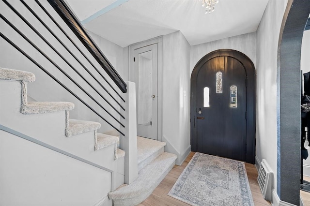 foyer featuring light hardwood / wood-style floors and a chandelier