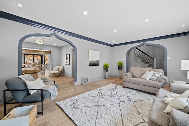 living room featuring light hardwood / wood-style flooring and ornamental molding