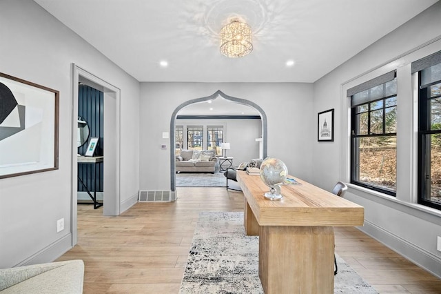 office area featuring light hardwood / wood-style floors and a notable chandelier