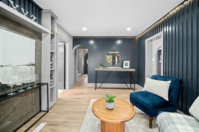 sitting room featuring built in features and light wood-type flooring