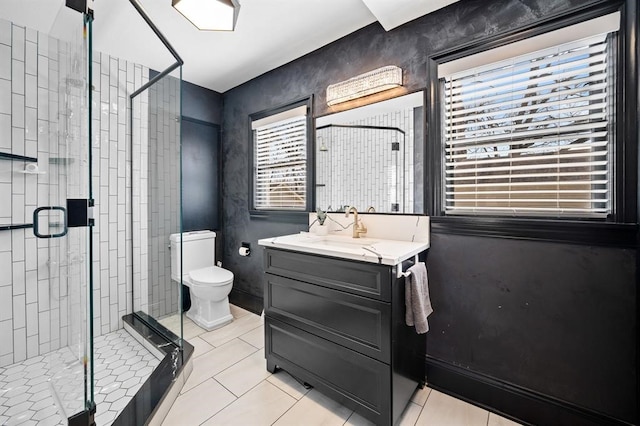 bathroom with tile patterned flooring, vanity, and a wealth of natural light