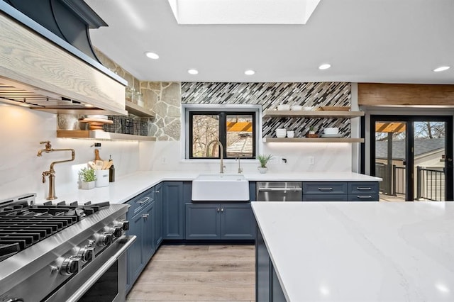 kitchen featuring light hardwood / wood-style flooring, french doors, sink, and stainless steel appliances